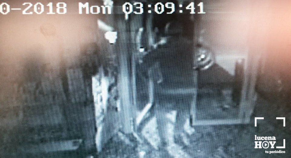 Uno de los ladrones sale del establecimiento con una caja de tabaco. Uno de los ladrones sale del establecimiento con una caja de tabaco.
