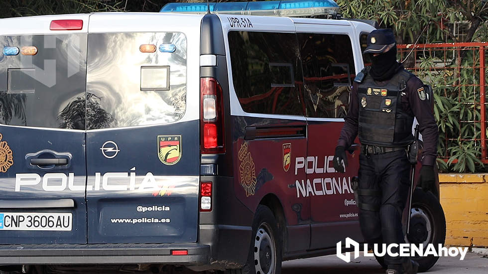  Un agente con el rostro cubierto sale de uno de los vehículos que participaron en la registro del inmueble situado junto a los accesos al parque empresarial Príncipe Felipe. Foto: LucenaHoy 