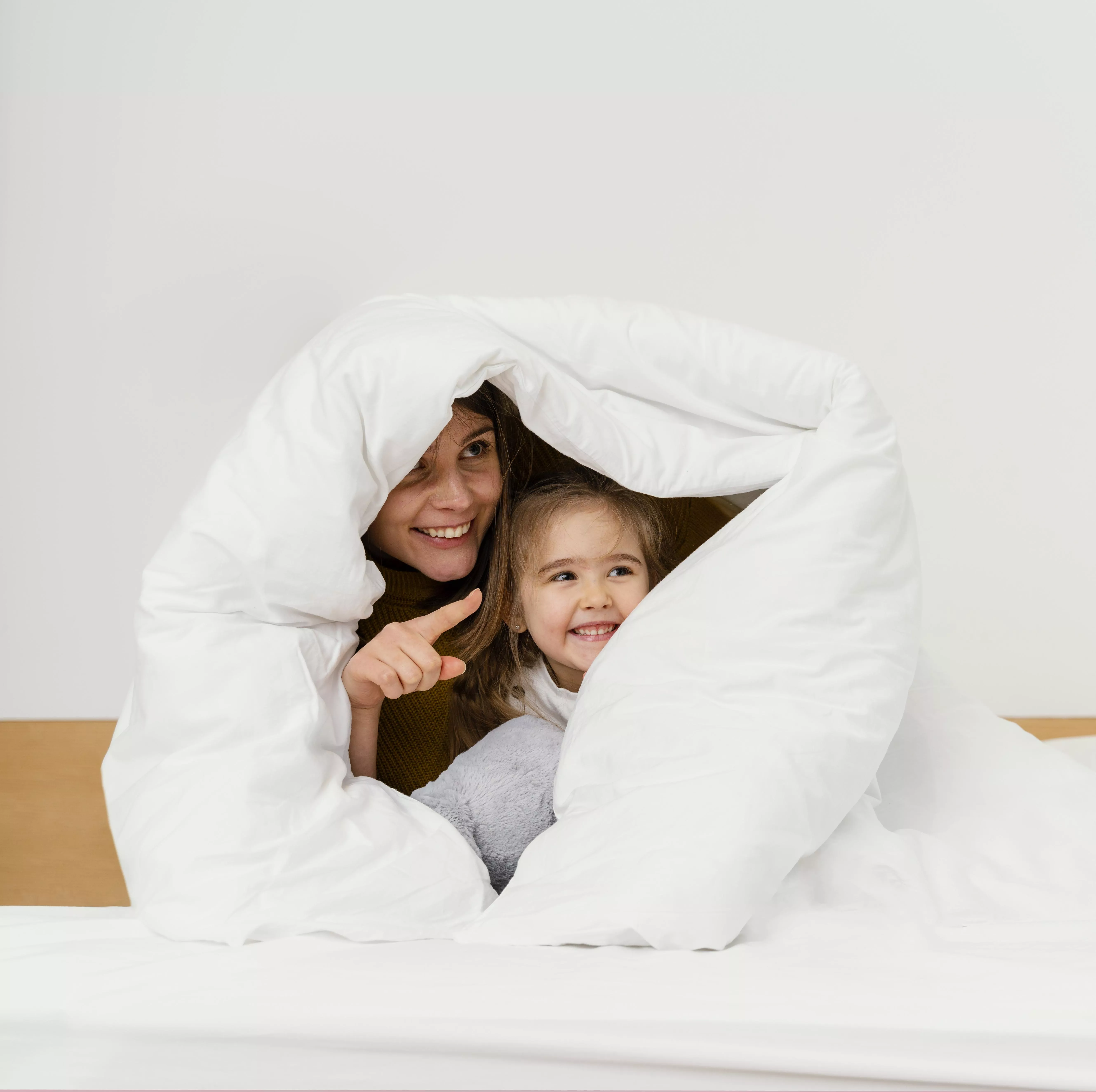 smiley mother kid hiding blanket