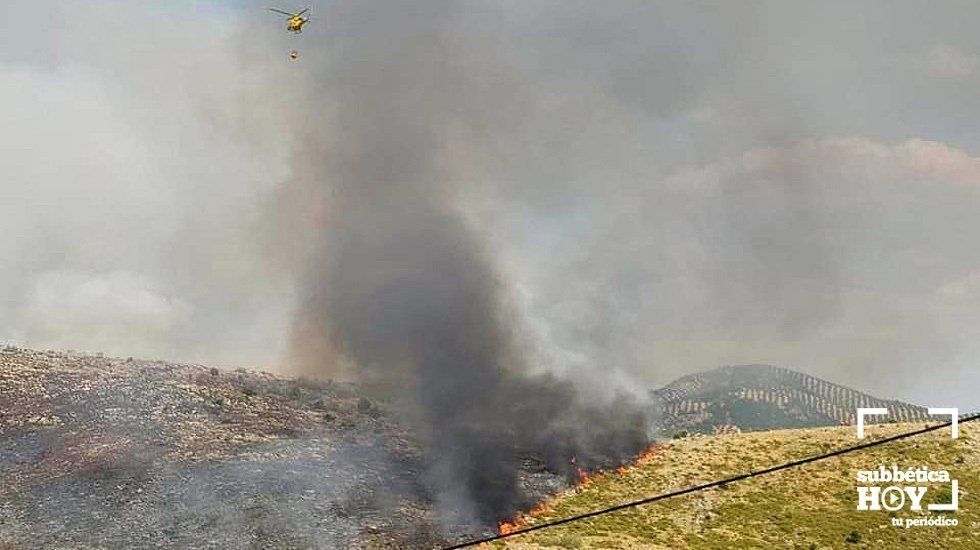  Un helicóptero lanza agua sobre las llamas que avanzan por el paraje natural de El Lanchar, en Rute. Foto: INFOCA y Policía Local Rute 